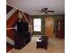 Living room with wood accent wall, sliding barn door, and neutral carpet at 401 Lawton Dr, Haw River, NC 27258