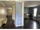 Open-concept living room featuring dark hardwood floors, light blue accent wall, and a chandelier light fixture at 401 Lawton Dr, Haw River, NC 27258