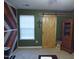 Living room with wood accent wall, sliding barn door, and neutral carpet at 401 Lawton Dr, Haw River, NC 27258