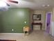 Living room with olive green accent wall, neutral carpet, and small console table at 401 Lawton Dr, Haw River, NC 27258