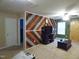 Living room with wood accent wall, neutral carpet, and ceiling fan with lights at 401 Lawton Dr, Haw River, NC 27258