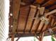 An outdoor patio area features detailed woodwork and a charming ceiling fan at 401 Lawton Dr, Haw River, NC 27258