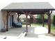 Covered patio area featuring a comfortable outdoor lounge set, perfect for relaxing and entertaining at 401 Lawton Dr, Haw River, NC 27258