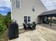Back patio with a table, chairs, barbecue and covered area with comfortable outdoor seating at 401 Lawton Dr, Haw River, NC 27258