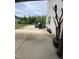 Concrete patio with outdoor seating, adjacent to the home and landscaping at 401 Lawton Dr, Haw River, NC 27258