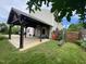 View of a covered pergola from the yard, complete with outdoor seating and landscaping at 401 Lawton Dr, Haw River, NC 27258