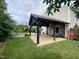 Landscaped yard featuring a covered pergola with outdoor seating and garden space at 401 Lawton Dr, Haw River, NC 27258