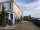 Manicured lawn extends to the side of the home, with stone accents and lush landscaping at 401 Lawton Dr, Haw River, NC 27258