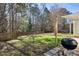 Backyard patio features a grill, canvas awning, and fenced yard at 405 Braxman Ln, Holly Springs, NC 27540