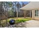 Backyard patio features a grill, canvas awning, and lush green grass at 405 Braxman Ln, Holly Springs, NC 27540