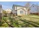 Backyard of a two-story home with a patio and well-maintained lawn at 405 Braxman Ln, Holly Springs, NC 27540