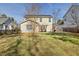 Backyard features a canvas-covered patio with chairs and a grill at 405 Braxman Ln, Holly Springs, NC 27540