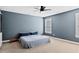 Calming bedroom with soft carpet, a ceiling fan, and natural light from the large window at 405 Braxman Ln, Holly Springs, NC 27540