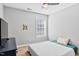Bedroom featuring a ceiling fan, large window, and a dark wood dresser at 405 Braxman Ln, Holly Springs, NC 27540