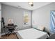 Bedroom with natural light, music keyboard, and comfortable space at 405 Braxman Ln, Holly Springs, NC 27540