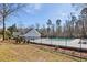 Community pool with a black iron fence surrounded by mature trees at 405 Braxman Ln, Holly Springs, NC 27540