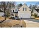 Charming two-story home with a manicured lawn and attached two-car garage at 405 Braxman Ln, Holly Springs, NC 27540