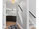 Hallway that offers views of the staircase and living room with hardwood floors at 405 Braxman Ln, Holly Springs, NC 27540