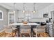Bright kitchen with granite countertops, stainless steel appliances, and a spacious island with seating at 405 Braxman Ln, Holly Springs, NC 27540