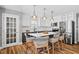 Bright kitchen with granite countertops, stainless steel appliances, and a spacious island with seating at 405 Braxman Ln, Holly Springs, NC 27540