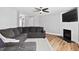 Inviting living room featuring a fireplace, tv, and hardwood floors at 405 Braxman Ln, Holly Springs, NC 27540