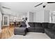 Open-concept living room with a large sofa and views to the dining room at 405 Braxman Ln, Holly Springs, NC 27540