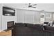 Comfortable living room with a fireplace, plush sofa, and neutral color palette at 405 Braxman Ln, Holly Springs, NC 27540