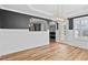 Bright living room featuring a large window, elegant lighting, and hardwood flooring at 405 Braxman Ln, Holly Springs, NC 27540