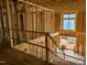 Interior view of framed construction with stairs and exterior view through opening at 405 Latimer Rd, Raleigh, NC 27609
