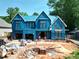 Under construction two-story home showing the framing and blue sheathing at 405 Latimer Rd, Raleigh, NC 27609