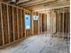 Unfinished room showing wood frame walls, new windows and subfloor at 405 Latimer Rd, Raleigh, NC 27609