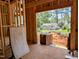 Garage under construction with exposed wood framing, brick, and a view of the neighborhood at 405 Latimer Rd, Raleigh, NC 27609