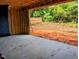 Unfinished garage with concrete floor and exterior access to the yard at 405 Latimer Rd, Raleigh, NC 27609