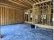 Interior view of a garage under construction with exposed wood beams and a concrete floor at 405 Latimer Rd, Raleigh, NC 27609