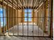View of living room featuring unfinished walls, floors and beams at 405 Latimer Rd, Raleigh, NC 27609
