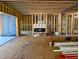 Living room under construction with exposed wooden framing and a modern fireplace at 405 Latimer Rd, Raleigh, NC 27609