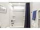 Bathroom featuring a white shower-tub combination with a dark shower curtain and silver fixtures at 4412 Beckel Rd, Willow Springs, NC 27592