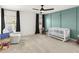 Bright Bedroom with soft carpet, white rocking chair, a colorful accent wall and ample natural light at 4412 Beckel Rd, Willow Springs, NC 27592