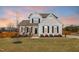 Charming two-story home with white siding, black shutters, and a well-manicured lawn at 4412 Beckel Rd, Willow Springs, NC 27592