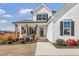 Charming two-story home with a well-manicured lawn and cozy front porch at 4412 Beckel Rd, Willow Springs, NC 27592
