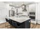 Bright kitchen with white cabinets, stainless appliances, island with seating and designer hardware at 4412 Beckel Rd, Willow Springs, NC 27592