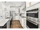 Close-up of the kitchen with quartz countertops, stainless steel appliances, and modern fixtures at 4412 Beckel Rd, Willow Springs, NC 27592