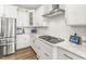 White kitchen featuring stainless steel appliances, white cabinets, gas range, and quartz countertops at 4412 Beckel Rd, Willow Springs, NC 27592