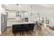 Bright kitchen features an island, stainless steel appliances, and an adjacent dining area with natural light at 4412 Beckel Rd, Willow Springs, NC 27592