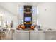 Open-concept living room with fireplace, soaring ceilings, a statement chandelier, and ample natural light at 4412 Beckel Rd, Willow Springs, NC 27592