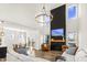 Inviting living room with tall ceilings, statement lighting, a modern fireplace, and open access to the dining area at 4412 Beckel Rd, Willow Springs, NC 27592