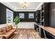 Office with built-in shelving, dual workstations, dark accent wall, and contemporary decor at 4412 Beckel Rd, Willow Springs, NC 27592
