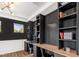 Office showcasing a built-in desk with storage, modern lighting, and dark accent wall at 4412 Beckel Rd, Willow Springs, NC 27592