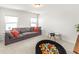 Bright playroom featuring a comfortable gray sofa, a small table and a colorful ball pit for  at 4412 Beckel Rd, Willow Springs, NC 27592