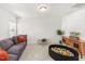 Bright playroom featuring a comfortable gray sofa, a small table, and a stylish wood entertainment center at 4412 Beckel Rd, Willow Springs, NC 27592